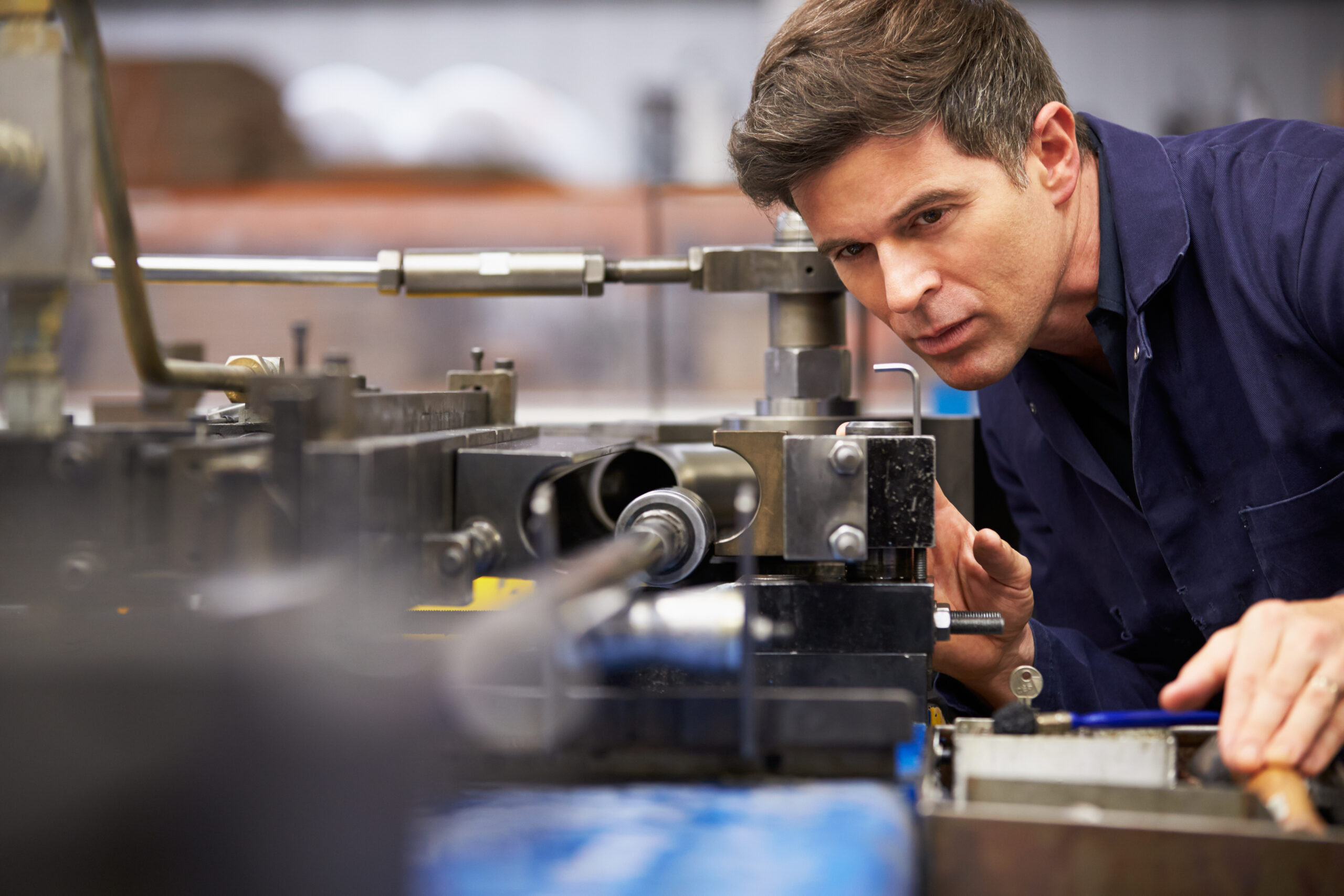 Factory engineer operating hydraulic tube bender