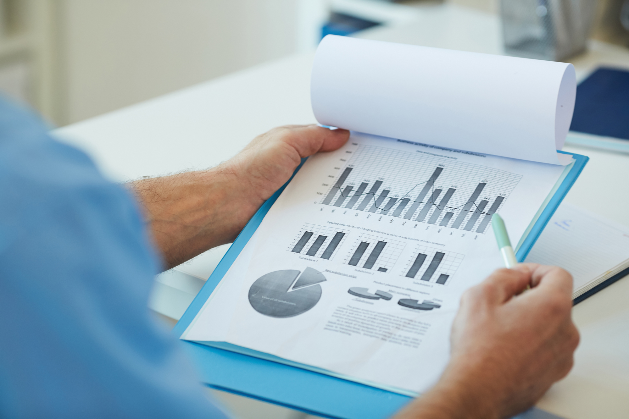 Unrecognizable doctor holding charts close up
