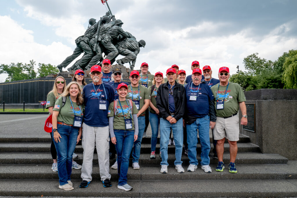 Veterans from Florida's Treasure Coast and Indian River State College employees gather at the U.S. Marine Corps War Memorial in Arlington, Virginia, during an Honor Flight mission.