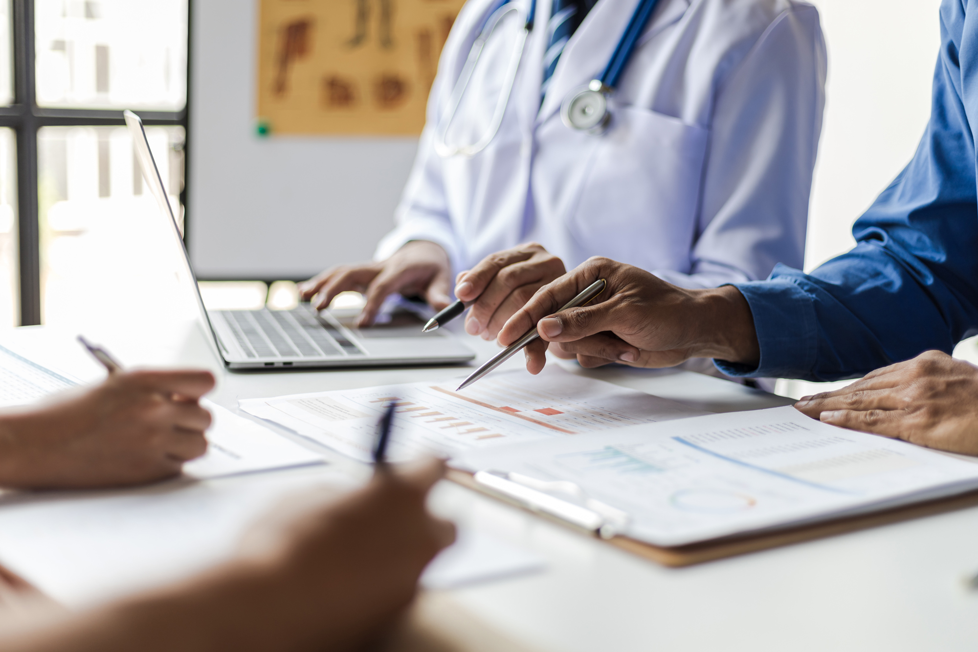 Team, medical analysts and doctors consulting with paperwork of