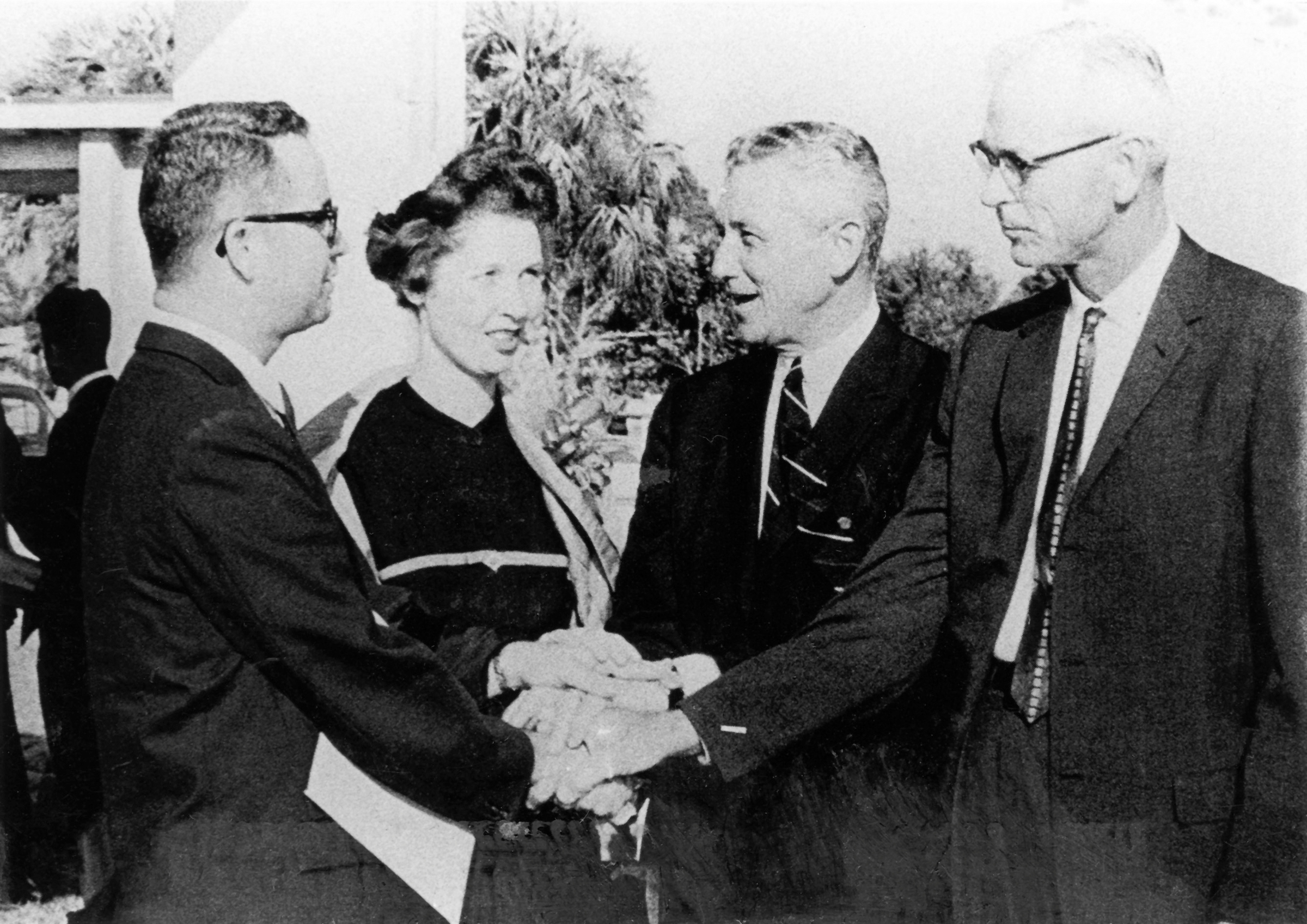 A black and white photo of Indian River Junior College President Max King and Mrs. King receiving congratulations from Governor LeRoy Collins and Senator Harry Kichliter on the establishment of Indian River Junior College.